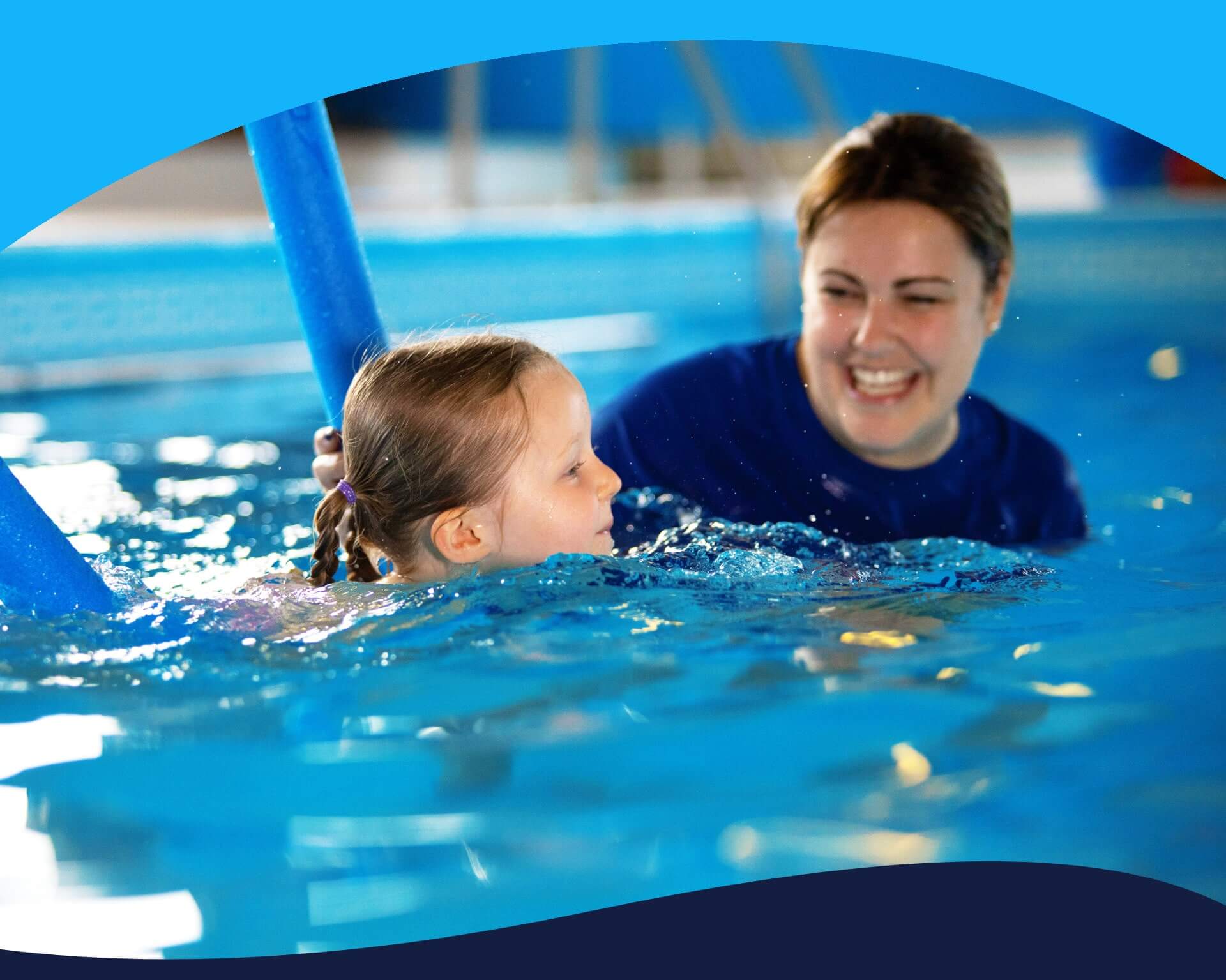 Swimming teacher with a swimmer on a woggle